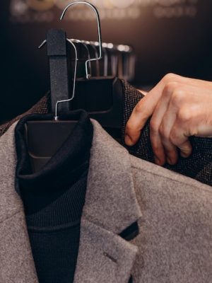 young-man-choosing-cloths-menswear-shop_1303-30951